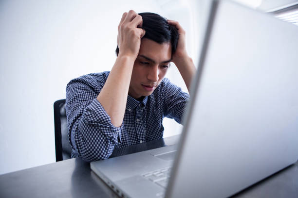 istock Male employees troubled with their heads 1095285216