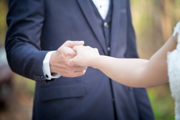 istock couple holding hands with nature background 1095287060