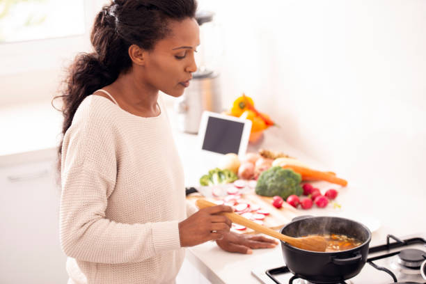 istock Woman stirring vegetable soup. 1095288324
