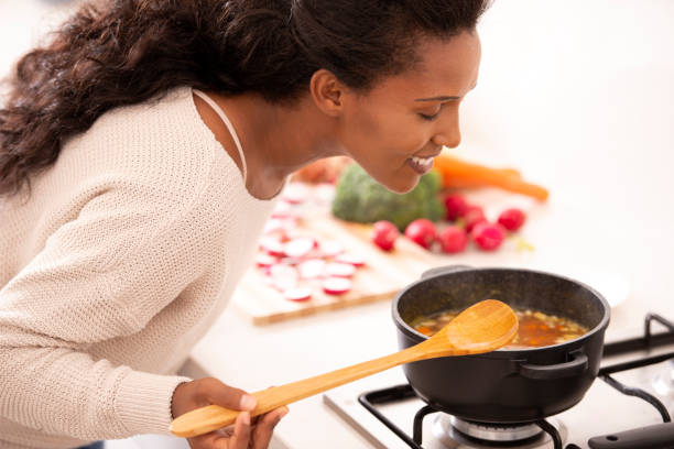 istock Woman smelling freshly cooked soup. 1095288674