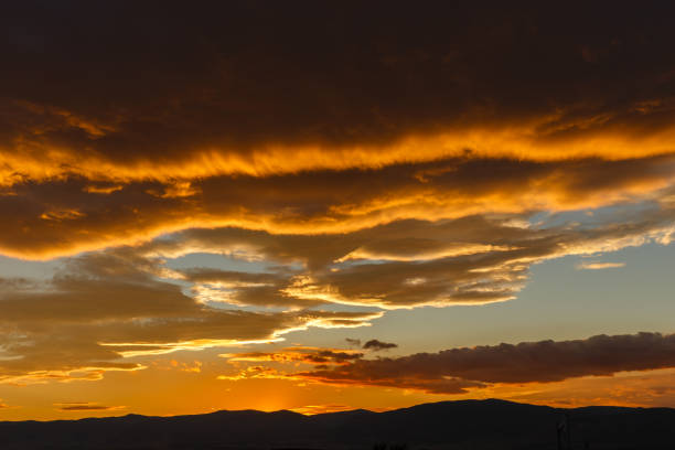 istock Sunset behind the dark heavy clouds 1095289092