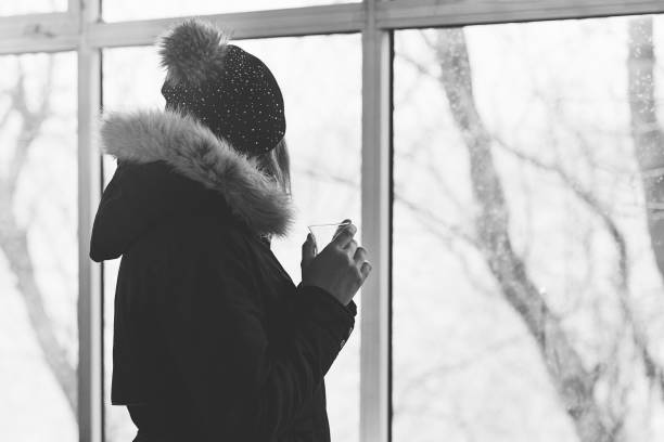 istock Unrecognizable woman drinks tea on winter terrace 1095289184