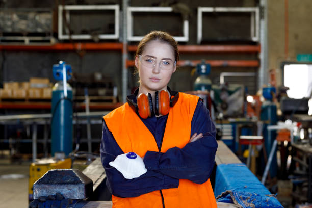 istock Determined Female Factory Worker Wearing Protective Clothing 1095293560
