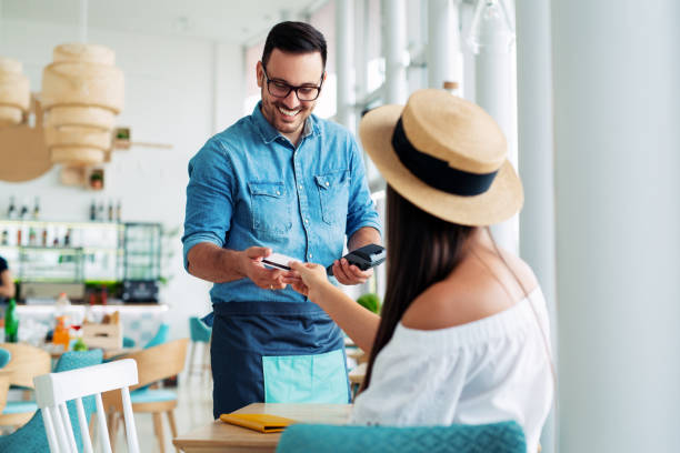 istock Woman paying by credit card in restaurant 1095296896