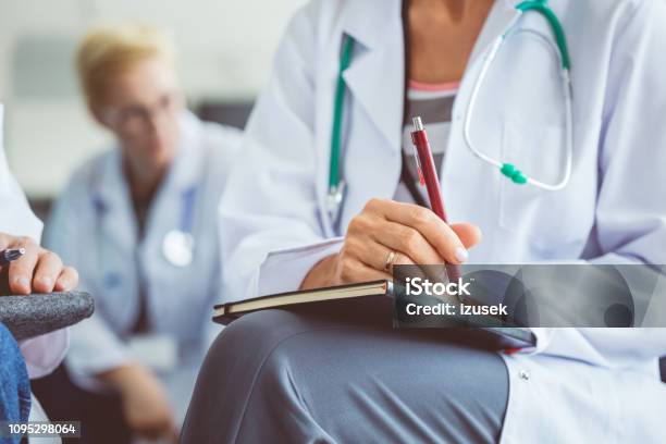 Female Doctor Making Notes During Seminar Stock Photo - Download Image Now - Healthcare And Medicine, Doctor, Education