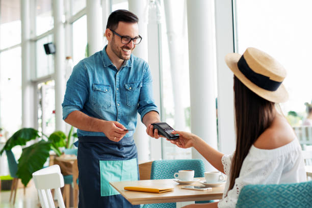 istock Woman paying by credit card in restaurant 1095298232