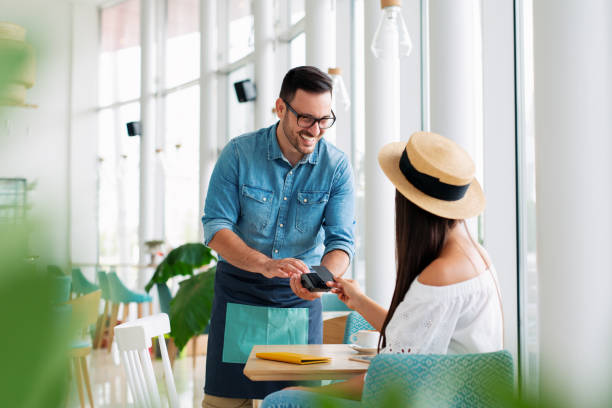 Woman paying by credit card in restaurant