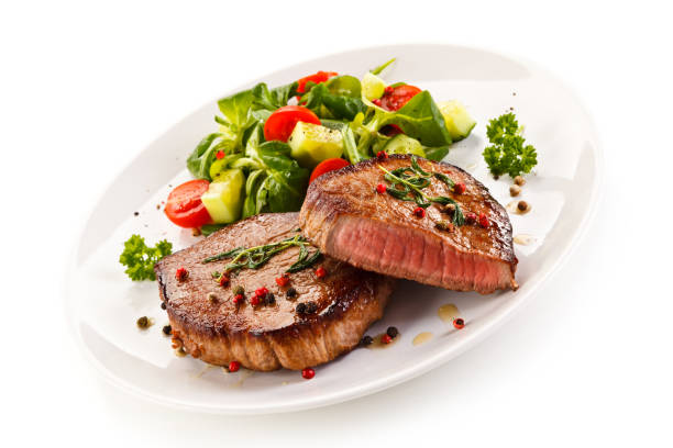 istock Grilled beefsteak and vegetables on white background 1095300604