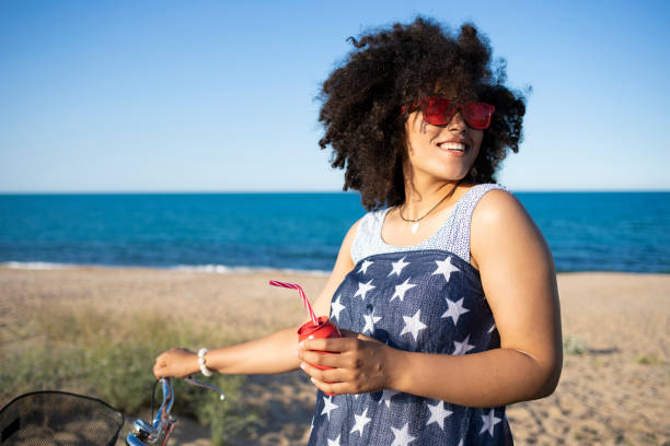 istock Woman with american flag drinking red cocktail 1095301630