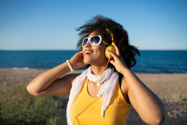 istock Cheerful african woman 
 in yellow 1095301652