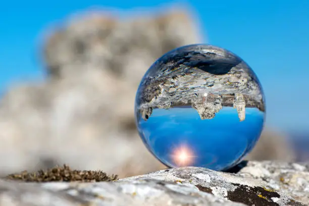Photo of Upside down landscape of Pobiti Kamani, The Stone Forest Natural Reserve near Varna in Bulgaria, Eastern Europe - reflection in a lens ball - selective focus, space for text