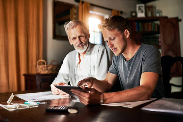 Here's a better explanation Shot of two men working on a project together at home college student and parent stock pictures, royalty-free photos & images