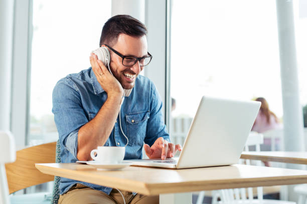 istock Businessman in modern headphones watching funny webinar. 1095309654