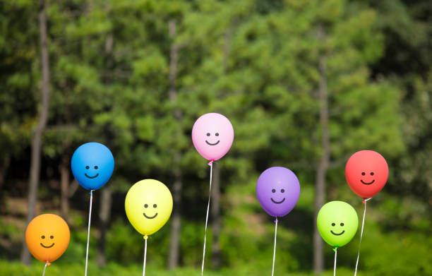 istock multicolored smiling balloons in the forest. 1095309994