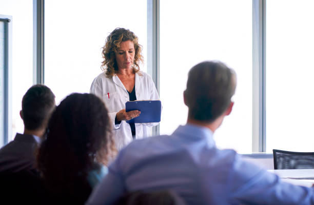 istock Doctor with clipboard sharing ideas in meeting 1095310570