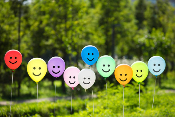istock colored air balloons floating in the green forest. 1095312734