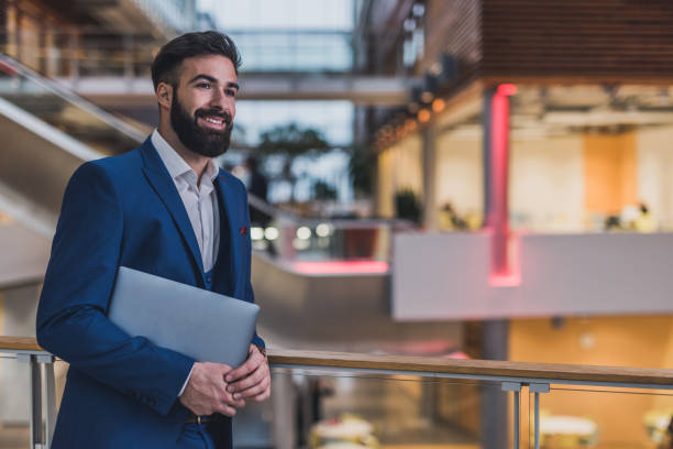 istock Happy business man holding laptop. 1095313842