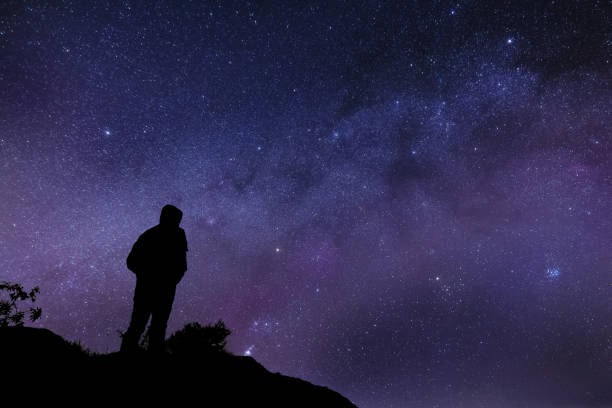 istock Silhouette of a lonely man watching the Milky Way 1095324346