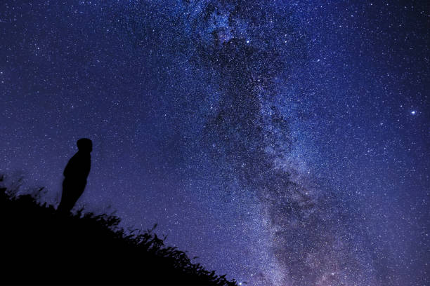 istock Silhouette of a lonely man watching the Milky Way 1095325152