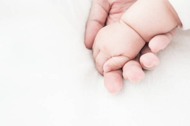 istock Baby new born hand in mother hand 1095331728