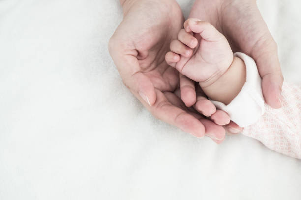 istock Baby new born hand in mother hand . 1095331864