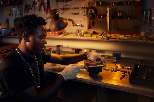 istock African ethnicity man in workshop cleaning moto cylinder 1095332992