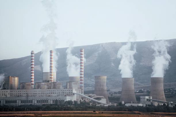 istock Smoke Emitting From Factories Against Sky 1095338088
