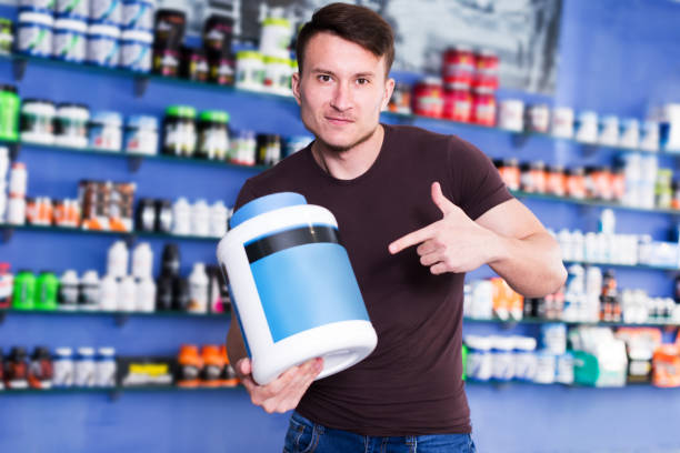 istock Guy holding sport food supplements 1095338748