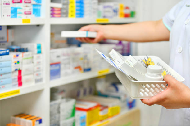 Pharmacist filling prescription in drugstore stock photo