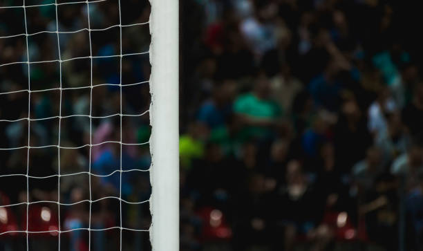istock Cropped Image Of Net Against Crowd In Stadium 1095342812