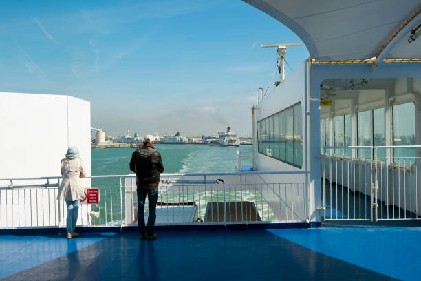 A channel ferry departs the Port of Calais, France Calais, France - April 11th, 2017: A cross-channel ferry departs the Port of Calais, France heading for Dover, England on a sunny spring afternoon. Calais is the largest port in France for passenger traffic. ferry dover england calais france uk stock pictures, royalty-free photos & images