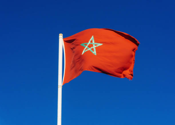 istock Real flag of morocco on blue sky background 1095347148