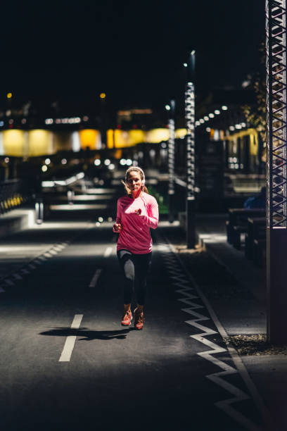 istock Woman Standing On Road At Night 1095347536