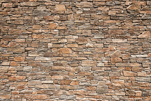 Hand crafted brick wall with granite stone. Use it for backgrounds or design elements and add your texte.