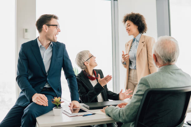 istock Coworkers smiling and talking at office 1095352902