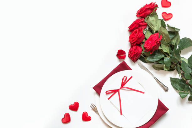 istock Valentine's day dinner. Romantic table setting with red roses. View from above. 1095358678