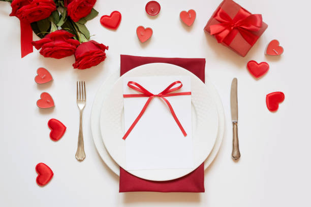 istock Valentine's day dinner. Romantic table setting with red roses. View from above. 1095358680
