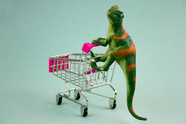 istock green dinosaur with shopping cart on blue background 1095360320