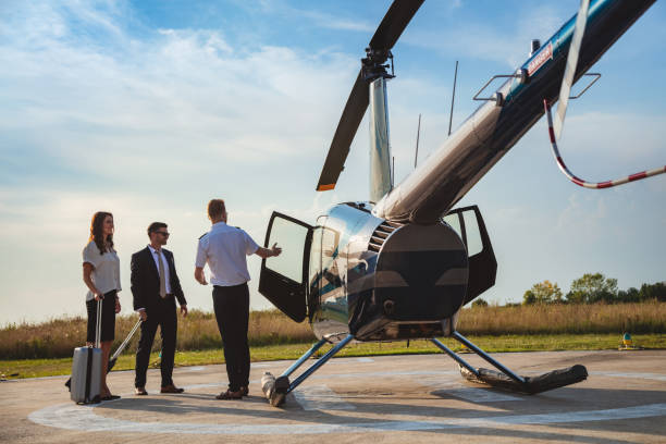 istock Pilot showing the interior of helicopter to passengers 1095363660