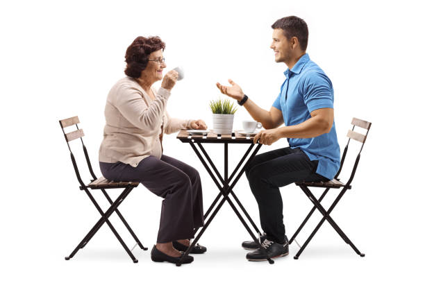 istock Elderly woman and a young man chatting and drinking coffee 1095369078