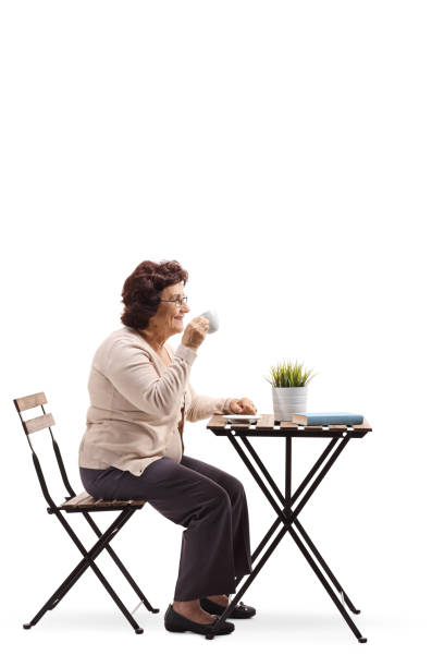 istock Elderly woman drinking coffee at a table 1095372704