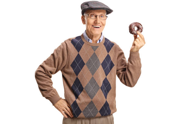 istock Cheerful senior man holding a chocolate donut 1095375484