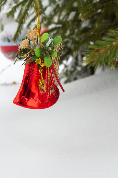 istock Christmas toy hanging on the tree outside in winter 1095377106