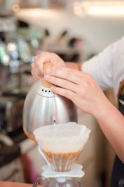 istock Barista holding hot water pouring in filter coffee maker 1095380798