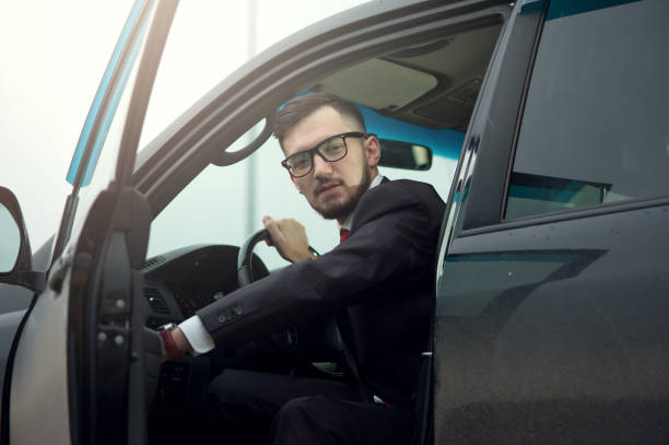istock Successful businessman driving luxury car. 1095389334