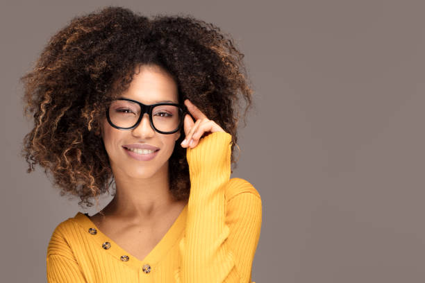 istock Young girl with an afro wearing eyeglasses. 1095392032