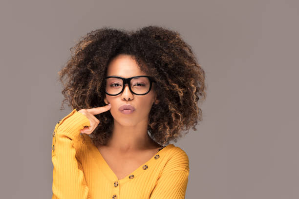 istock Young girl with an afro wearing eyeglasses. 1095392096