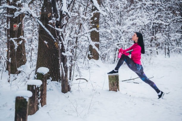 istock Young women stretching before jogging in trough the woods 1095396840
