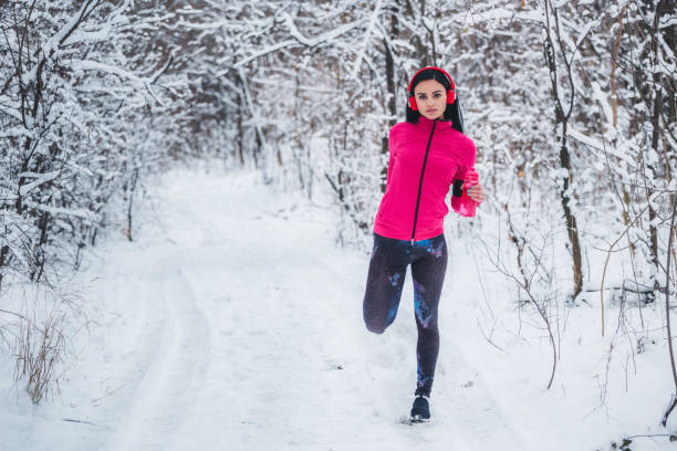 istock Young women stretching before jogging in trough the woods 1095397422