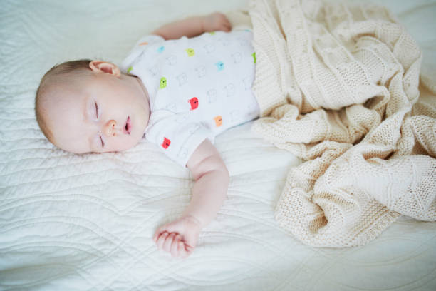 istock Baby girl sleeping under knitted blanket 1095402584